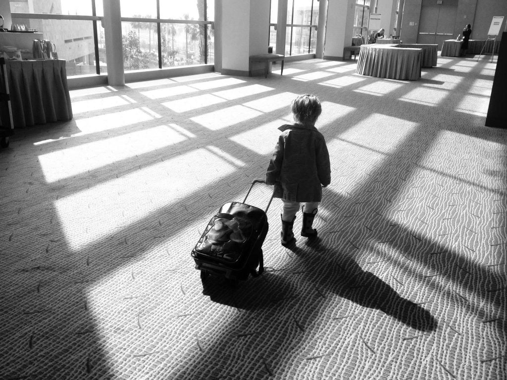 child pulling a suitcase