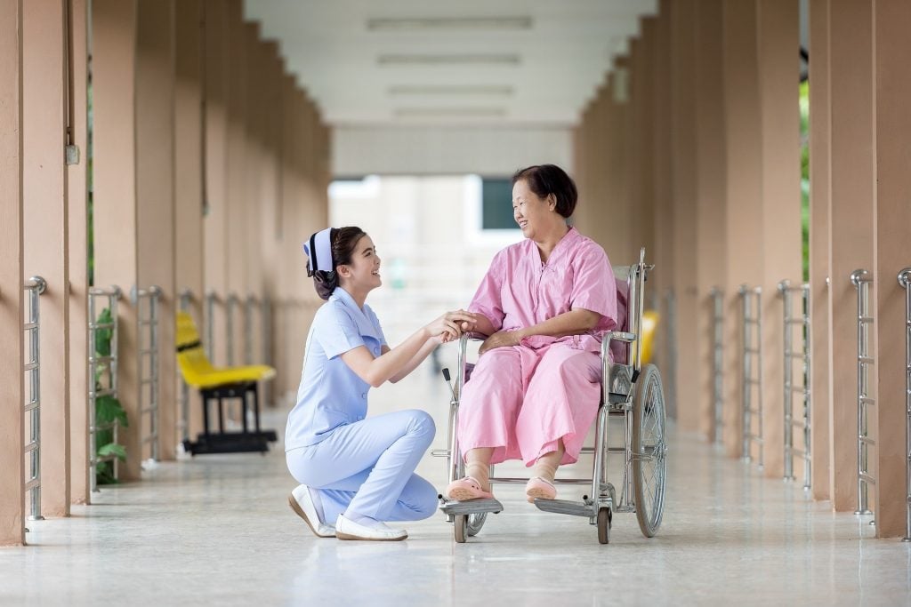 thai-nurse-with-elderly-woman-in-nursing-home