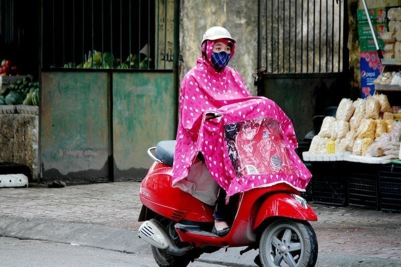 asian-woman-rainy-season-motorbike-rain-poncho