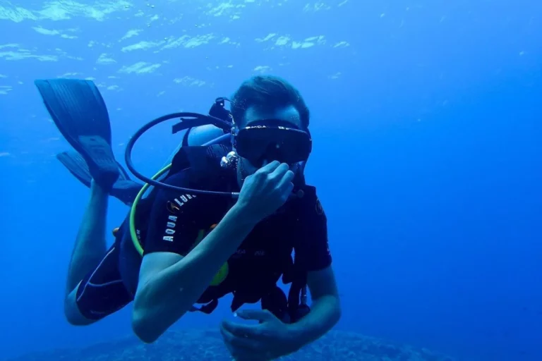 A dive instructor teaches his trade off the coast of one of Thailand's famous beaches