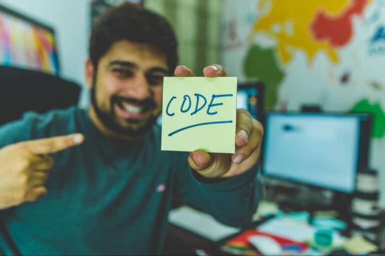 A software engineer creates and displays a sign saying, "Code"